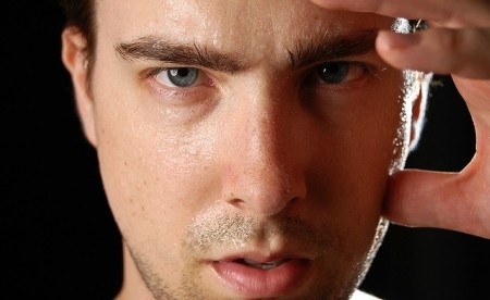 A guy experiencing night sweats as an HIV symptom.