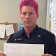 A photo of a police officer with pink hair.