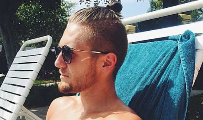 A photo of a sexy guy with a topknot.