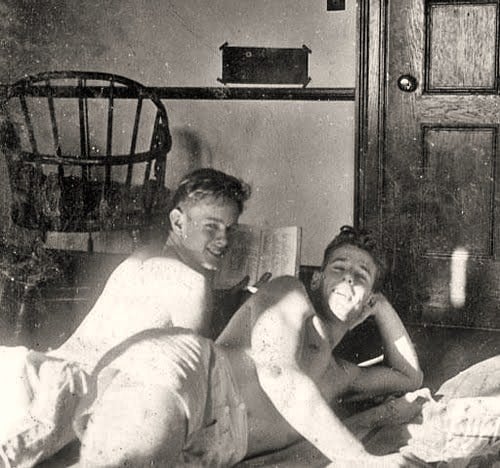 A gay couple cuddling in their home.