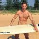 This is a photo of model Max Emerson about to go surfing.