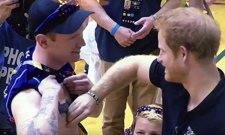 This is a photo of Prince Harry pinching a nipple.
