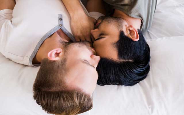 A gay couple in bed.
