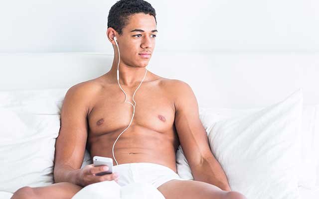 This is a photo of a young man listening to music.