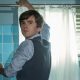 Norman Bates putting up a shower curtain