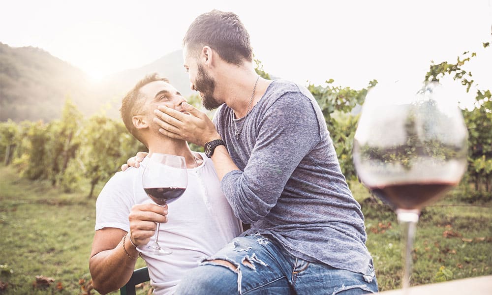 Gay couple drinking wine