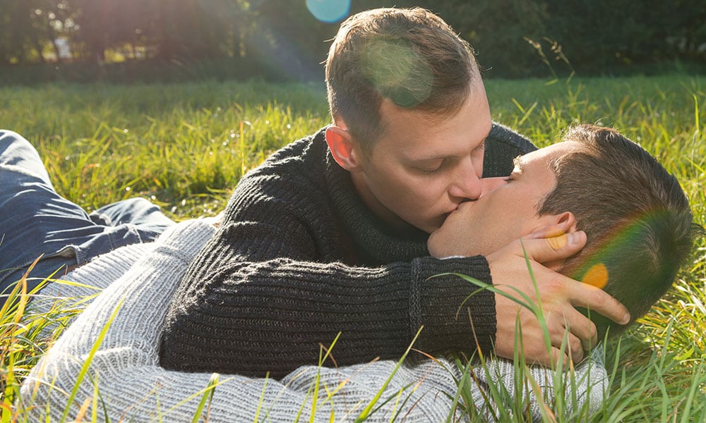 Young gay couple kissing