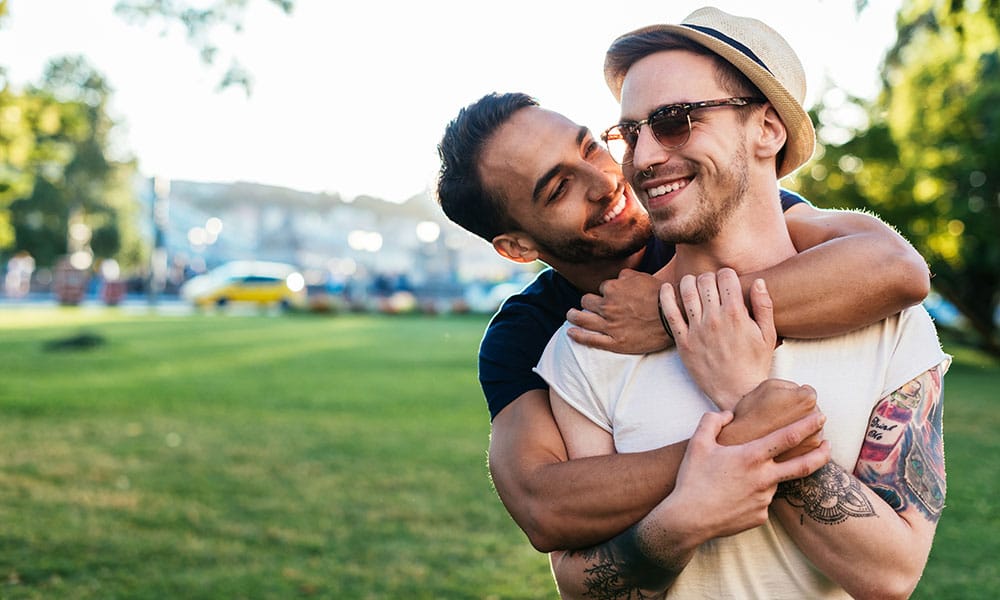 Multi ethnic gay couple hugging