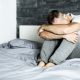 Anxious man sitting on a bed