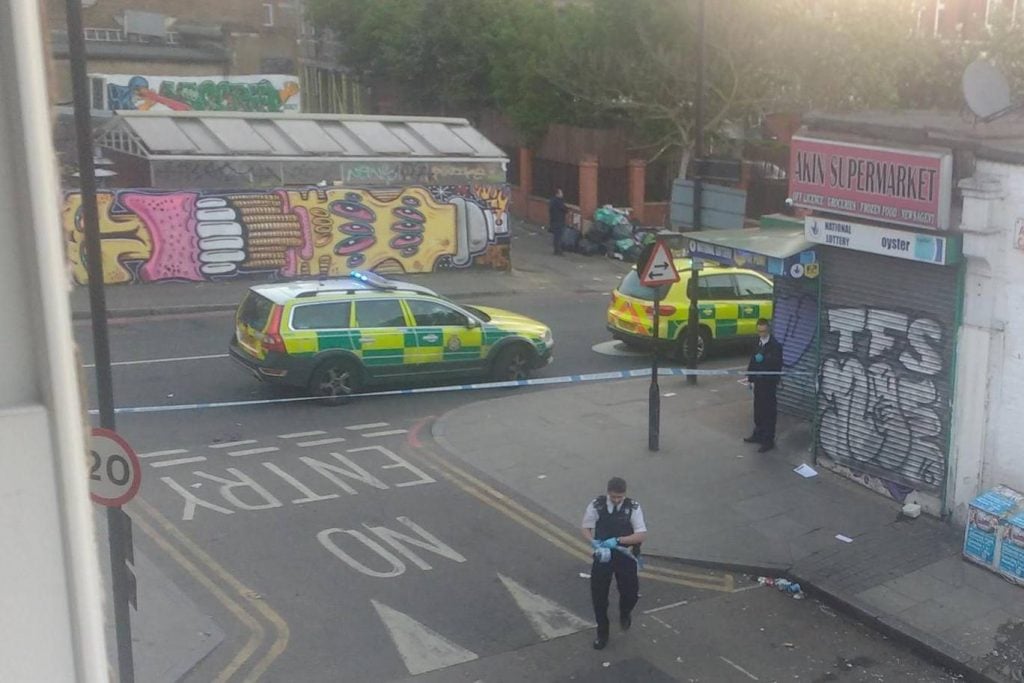 Police on the scene of the attack in Dalston