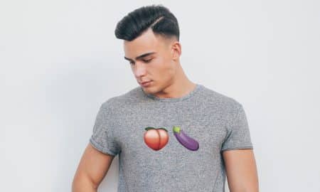 Guy wearing an eggplant and peach emoji t-shirt