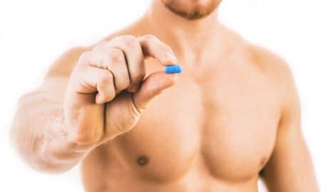 Man holding a PrEP pill