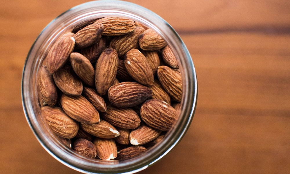 A jar full of almonds. 