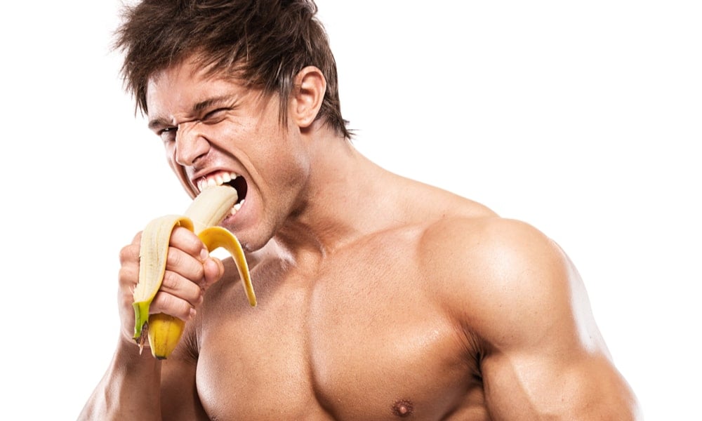 Man eating a banana to boost testosterone