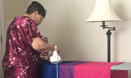 Grandmother ironing her bisexual Pride flag