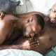 Gay black couple relaxing in bed