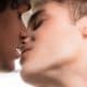 Two male teens about to kiss