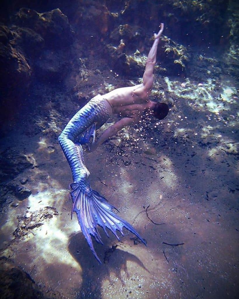 Merman swimming underwater