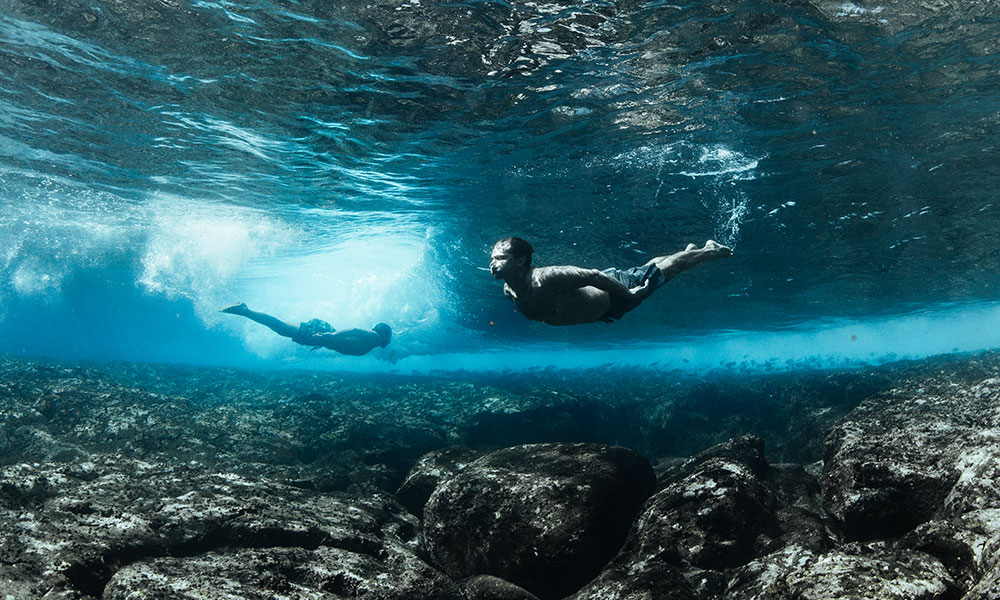 Two men swimming underwater in ocean, Kalapana, West Puna, Hawaii, America, USA