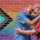 older male couple embracing and smiling