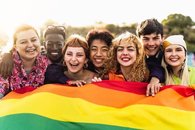 Diverse young friends celebrating gay pride festival