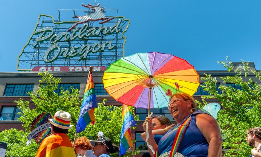 Portland OR, USA - June 17, 2018: The crowd moves under the famous Portland Sign during the 2018 Pride Parade through the streets of downtown Portland.