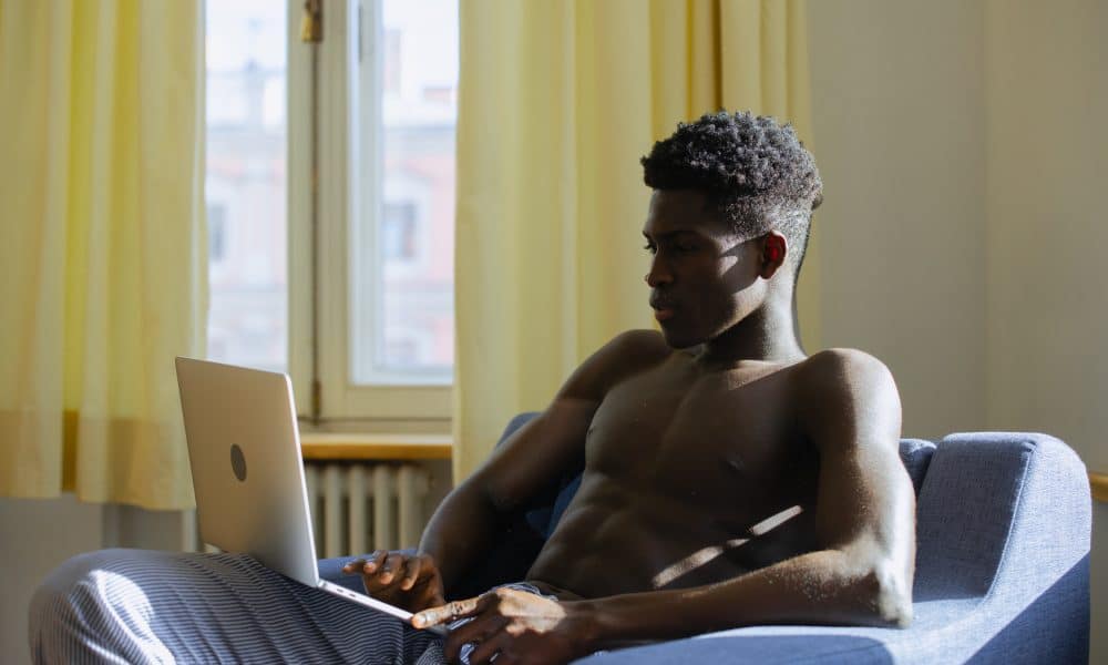 Shirtless man on laptop
