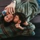 Gay couple on bed with iphone