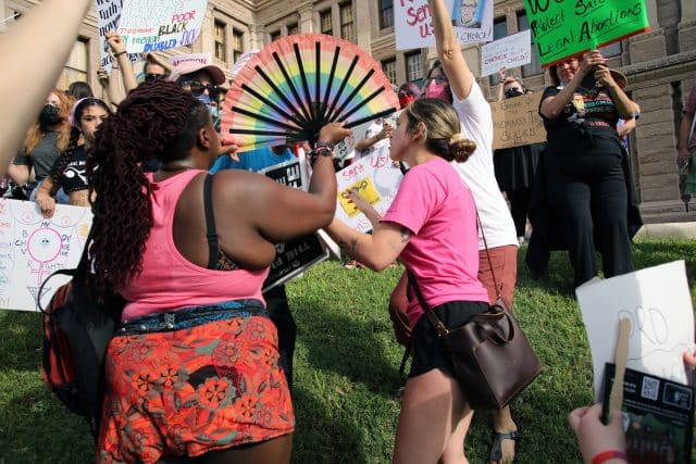 Pro-choice activists block pro-life activists at the Women's March rally at the Capitol protesting Texas' abortion law that bans abortions after six weeks of pregnancy.