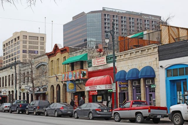 Bars, restaurants and other businesses in the Sixth Street Historic District, a major tourist destination that is listed in the National Register of Historic Places, Austin.