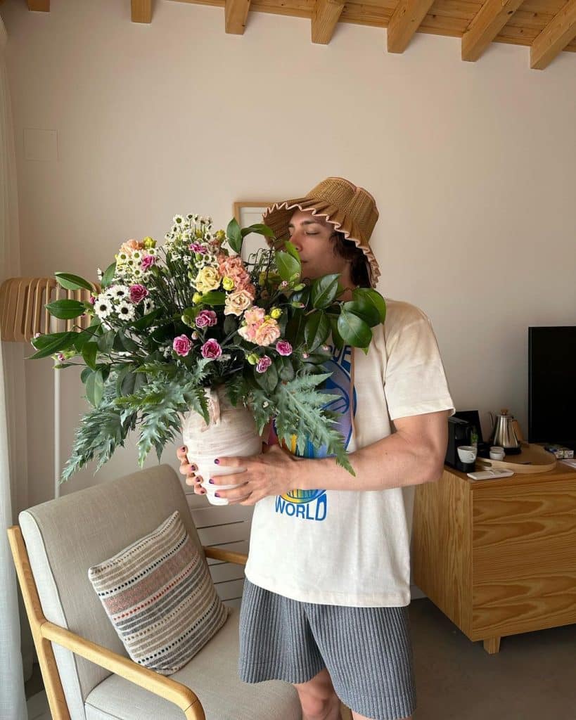 This is a photo of Cody Fern with flowers.