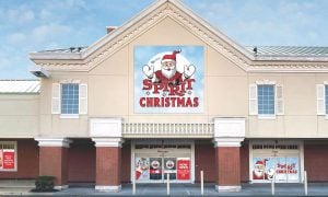 Exterior of a Spirit Christmas store featuring a large sign with Santa Claus above the entrance.