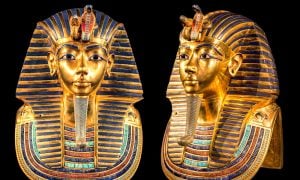 Golden death mask of King Tutankhamun with intricate details in blue and gold.