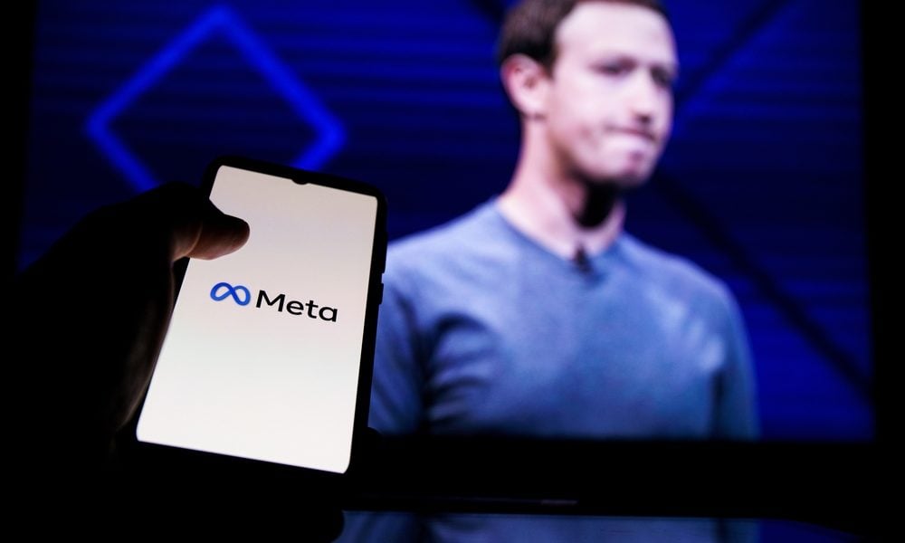 Kaunas, Lithuania 2022 - April 14: Meta logo on screen and Mark Zuckerberg is a Chief Executive Officer of Metaverse in background