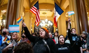 Hundreds of Iowa residents gathered at the state Capitol Thursday, waving Pride flags in protest of a controversial bill that seeks to remove gender identity as a protected class under Iowa’s Civil Rights Act.