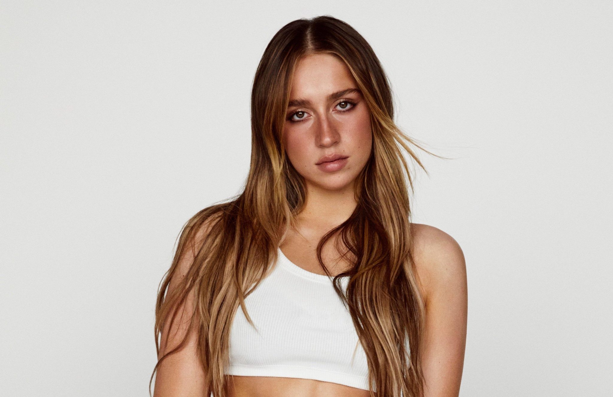 Rising pop star Tate McRae is opening up about her strong bond with her LGBTQ+ fans, admitting they are her "favorite" and sharing that her entire team is LGBTQ+.