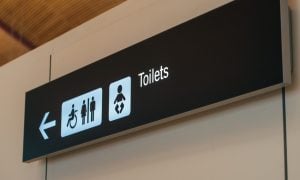 Toilet sign direction at airport