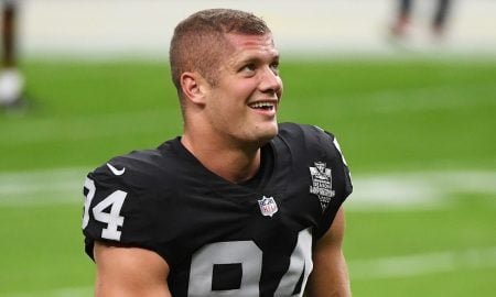 Carl Nassib #94 of the Las Vegas Raiders flexes while smiling during warmups before a game against the Denver Broncos at Allegiant Stadium on November 15, 2020 in Las Vegas, Nevada.