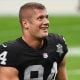 Carl Nassib #94 of the Las Vegas Raiders flexes while smiling during warmups before a game against the Denver Broncos at Allegiant Stadium on November 15, 2020 in Las Vegas, Nevada.