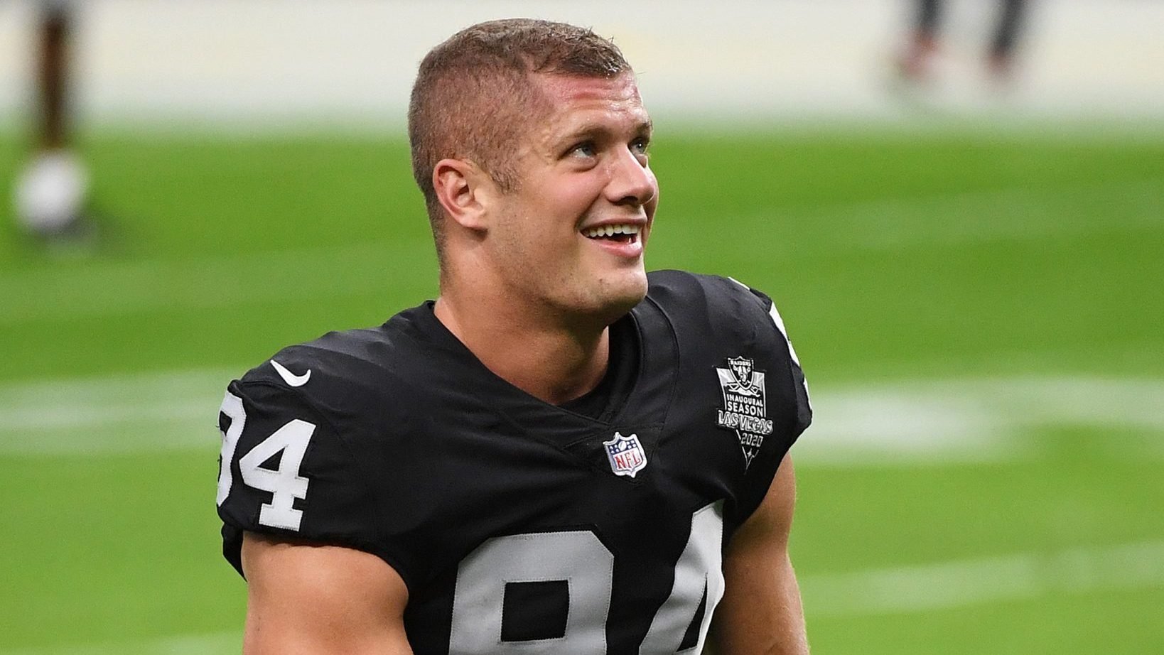 Carl Nassib #94 of the Las Vegas Raiders flexes while smiling during warmups before a game against the Denver Broncos at Allegiant Stadium on November 15, 2020 in Las Vegas, Nevada.